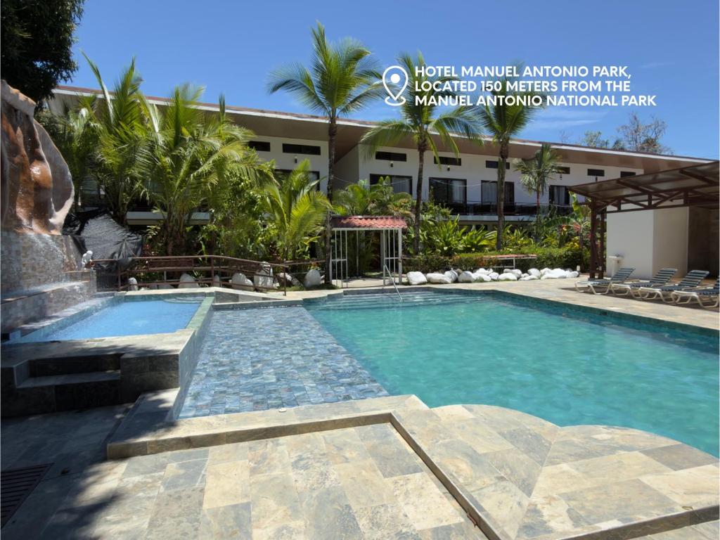 a swimming pool in front of a building at Hotel Manuel Antonio Park in Manuel Antonio