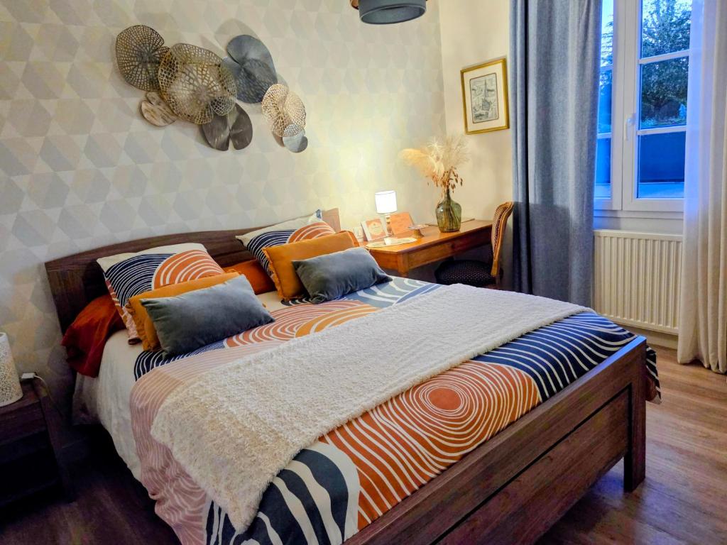 a bedroom with a bed with an elephant head on the wall at chambre d'hôte chez Mimidid in Le Landreau