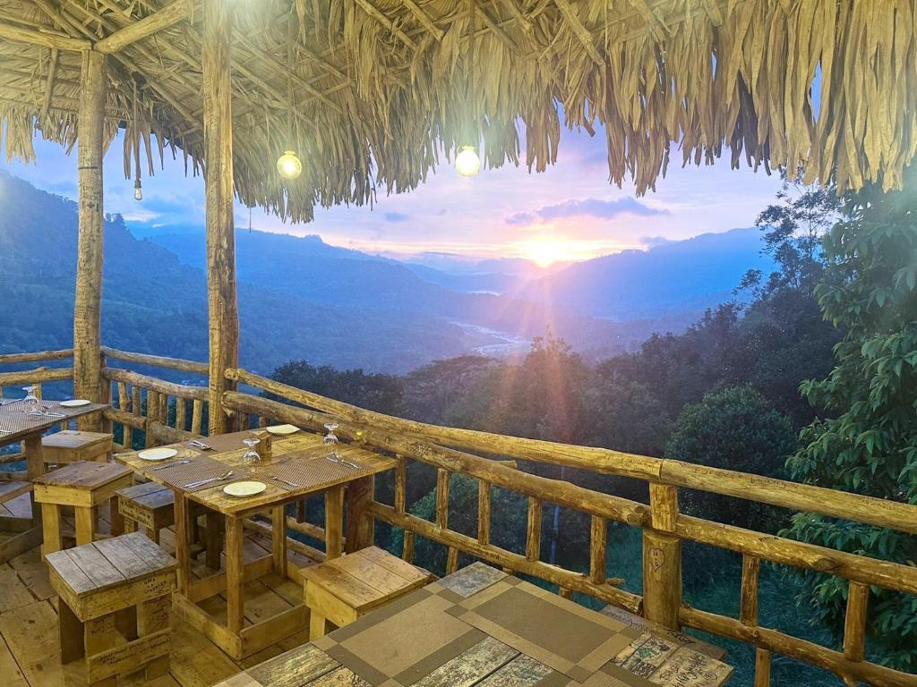 a restaurant with tables and a view of the mountains at The Chill Heights Ramboda in Ramboda