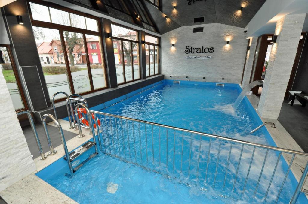 a large plunge pool in a building with windows at Stratos in Łeba