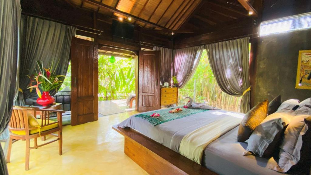 a bedroom with a large bed and a window at Maso Christian Villa Canggu in Tumbak Bayuh