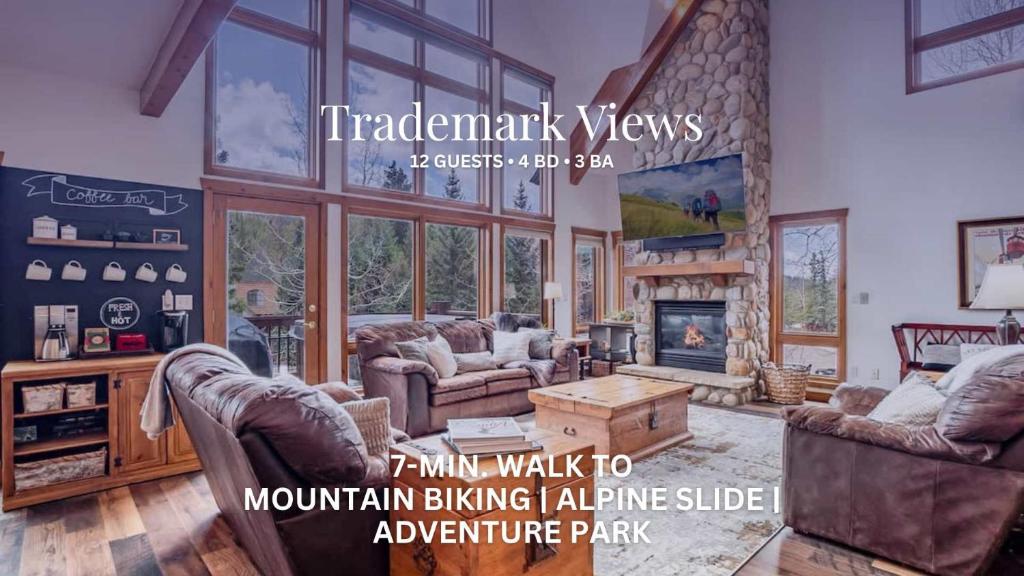 a living room with couches and a fireplace at Trademark Views in Winter Park