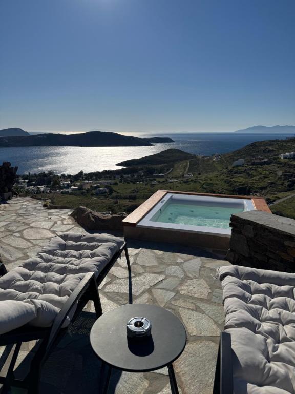 a patio with a pool and a table and chairs at To Petrino Serifos in Livadakia