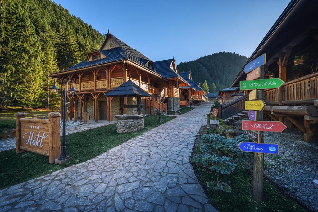 a street sign in front of a log cabin at Hotel U dobrého pastiera in Ružomberok