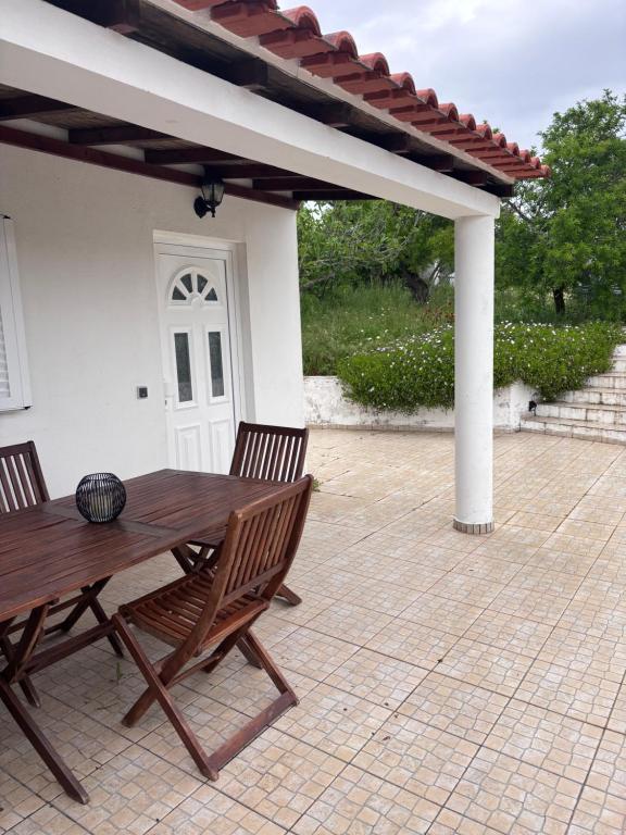 a wooden table and two chairs on a patio at Casa do Campo in Carvoeiro