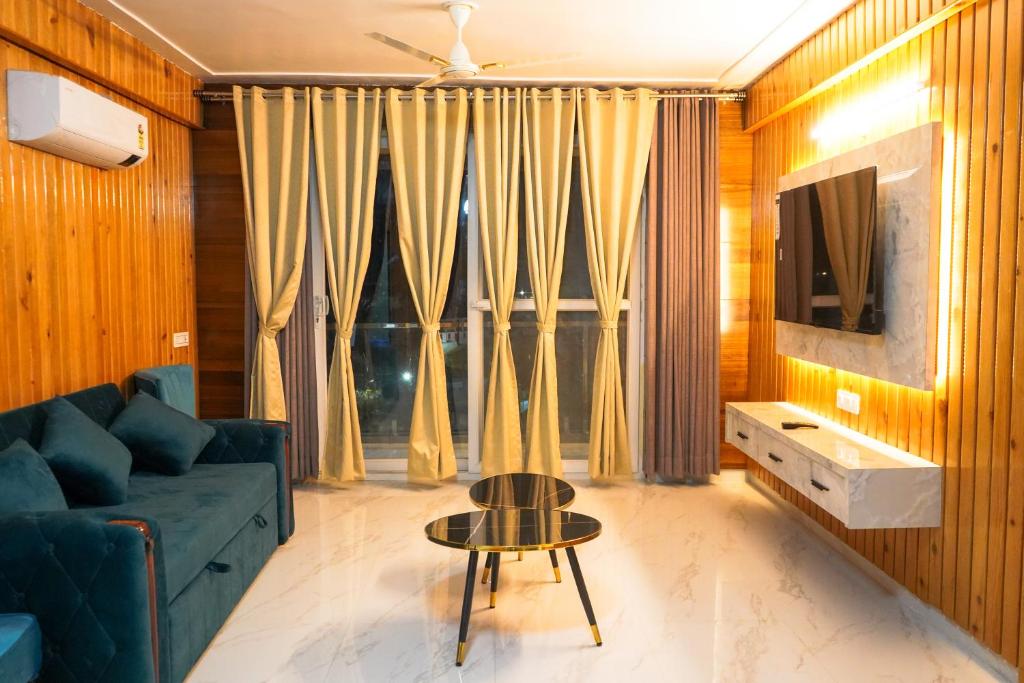 a living room with a couch and a table at Mount kirola stay in Bhowāli