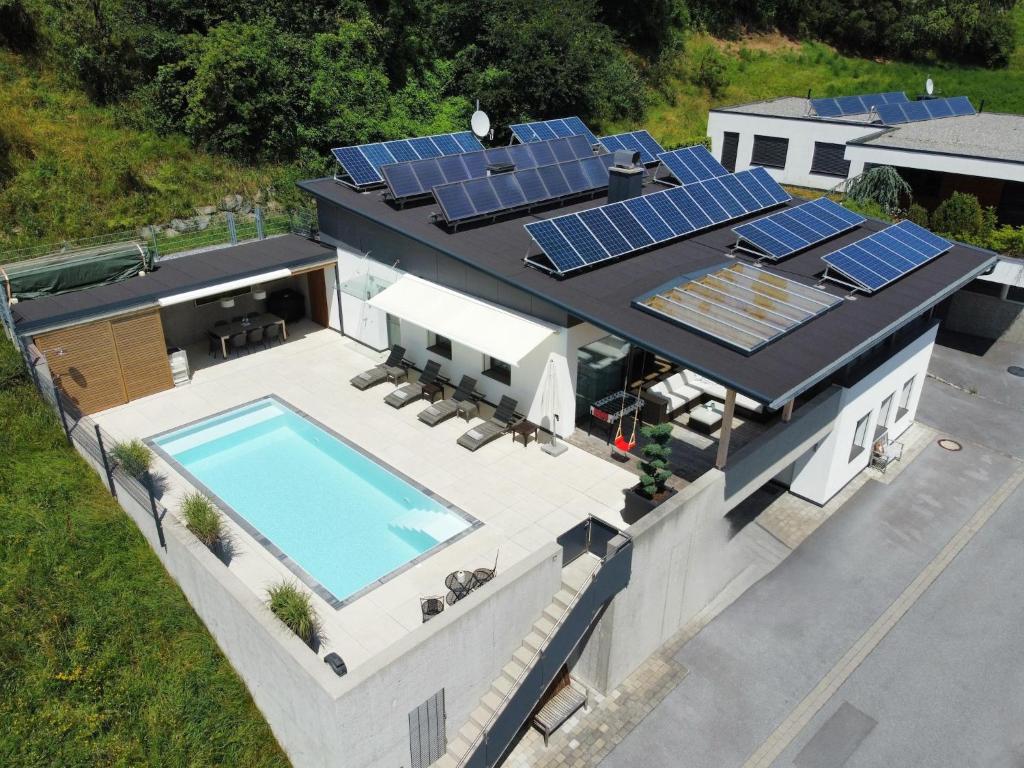 an aerial view of a house with solar panels on the roof at Villa in Tyrol with pool in Stanz bei Landeck