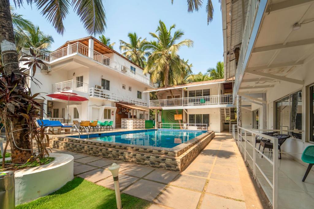 an exterior view of a house with a swimming pool at Beach Walk Resort Walk In Morjim Beach Goa in Morjim