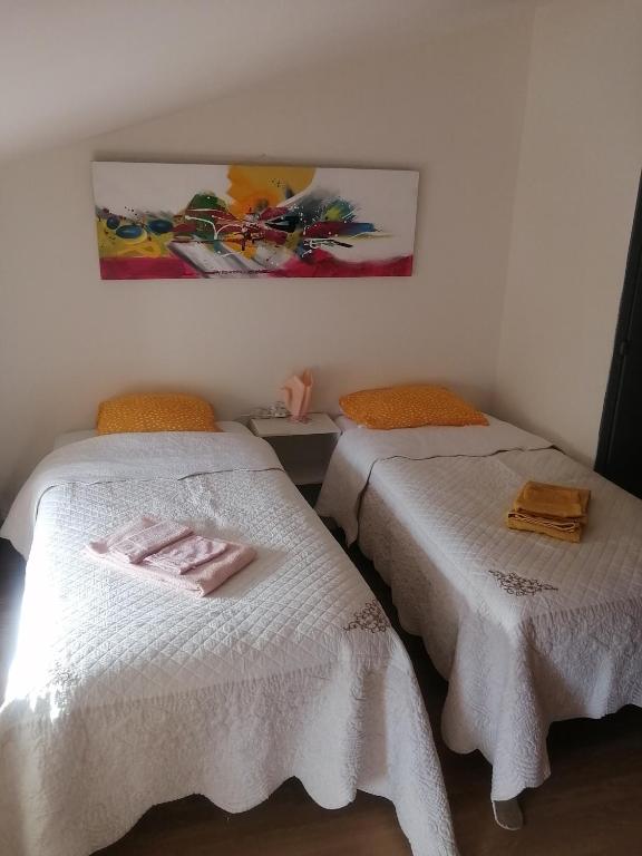 a room with two beds with towels on them at La Clef in Saint-Julien-Molin-Molette