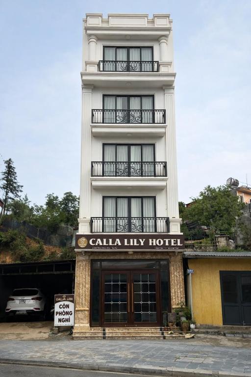 a tall white building with a callahan luxury hotel at Calla Lily Hotel in Sapa