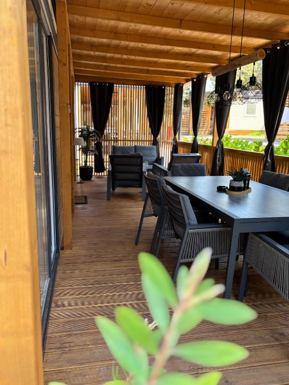 a dining room with a table and chairs at Mobile home TIM in Biograd na Moru