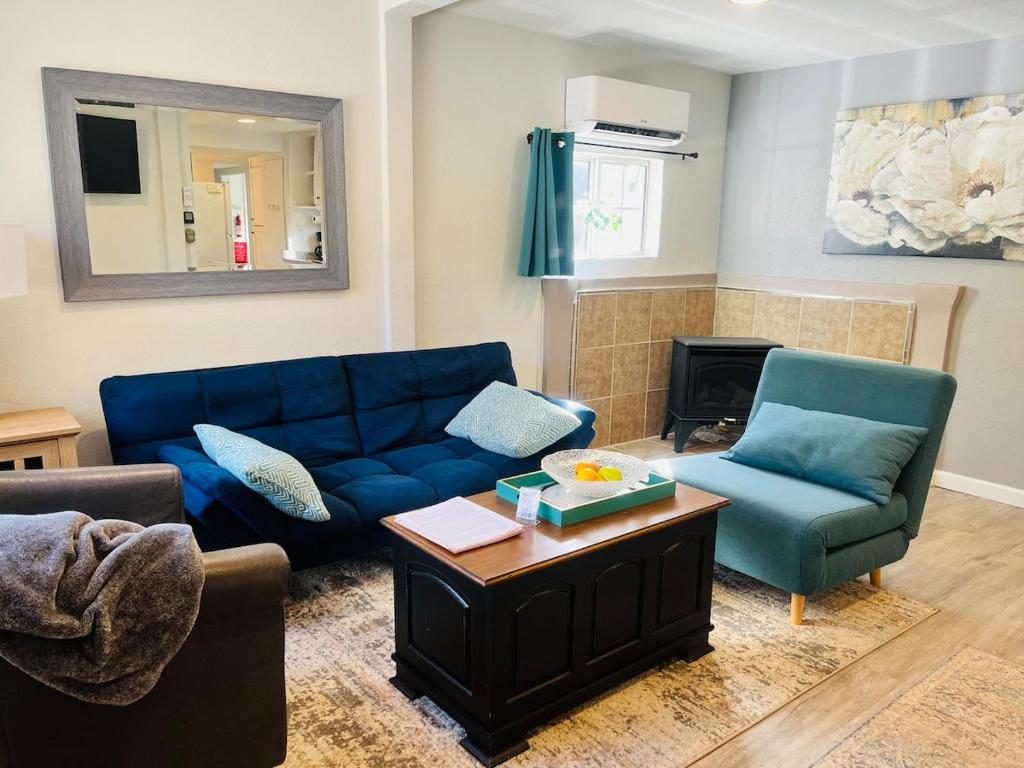 a living room with a blue couch and two chairs at Dafna, Unit 4 in Cromberg