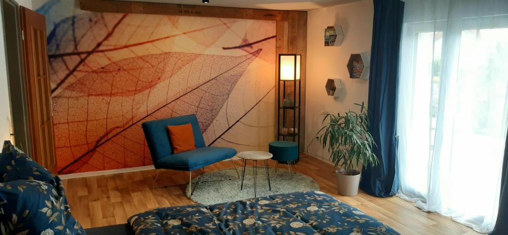 a living room with a chair and a painting on the wall at Ferienwohnung Oberhof in Murg