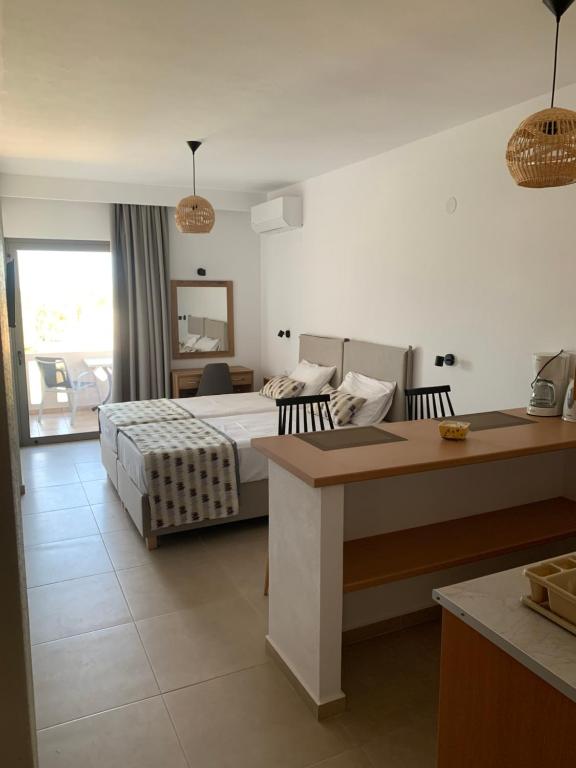 a hotel room with a bed and a desk at Anemoni Studios in Plakias