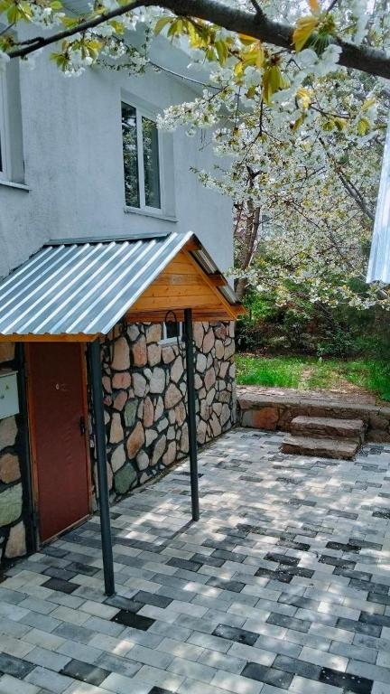 a building with a wooden roof and a stone wall at Chimgan Mountain in nature in Chimgan