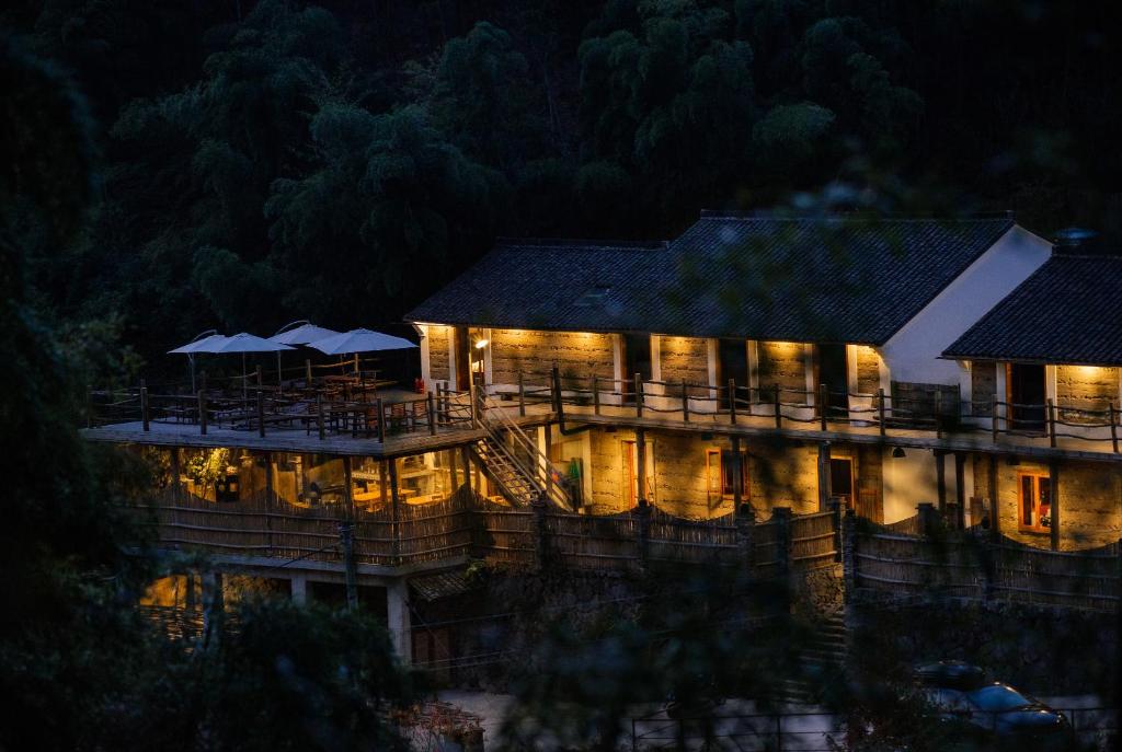a building lit up at night with lights at Moganshan Solvang Village Boutique Hotel in Deqing