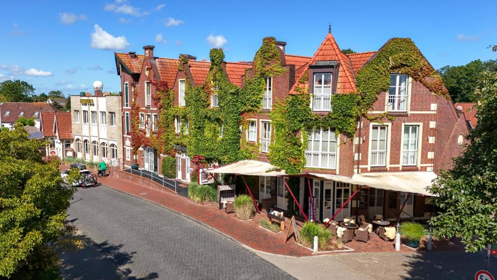 a rendering of a large brick building with ivy at Hotel Altes Zollhaus in Horumersiel
