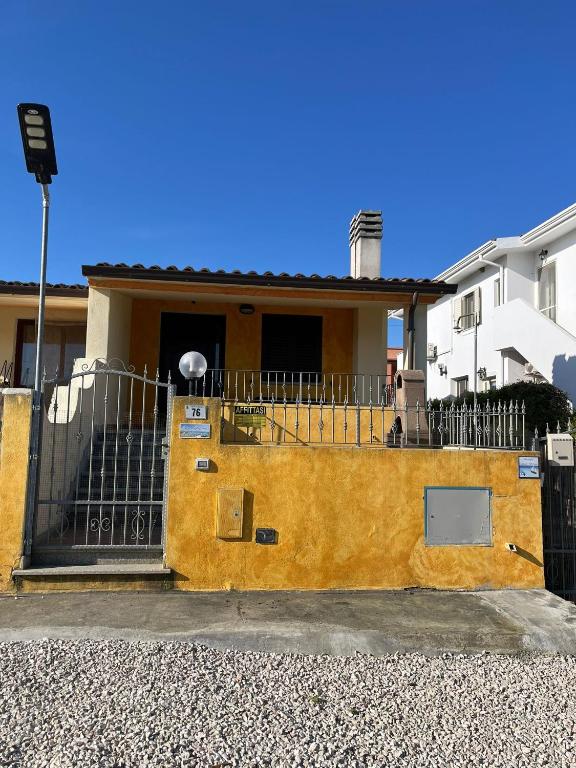 a yellow house with a black gate in front of it at Casa Antonietta in Santa Lucia