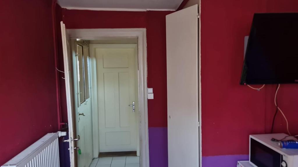 a room with a hallway with a door and a television at Gasthasu Weisses Schäfli in Arbon