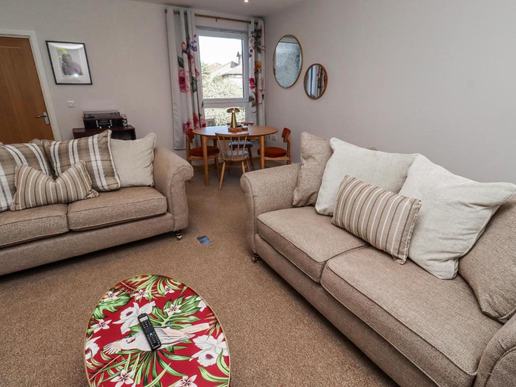 a living room with two couches and a table at Amber Rose in Berwick-Upon-Tweed