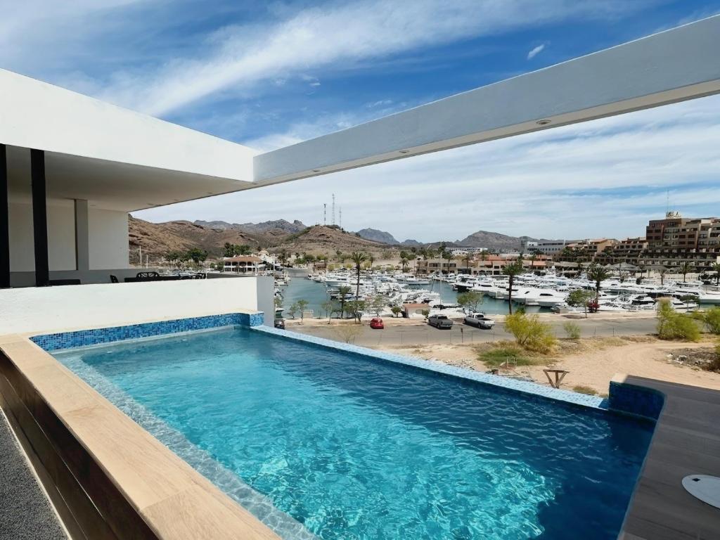a pool on the roof of a house with a view at Casa Puerto Azul in San Carlos
