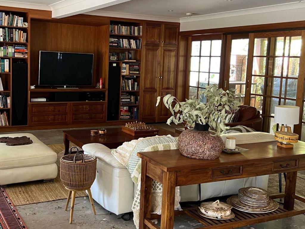 a living room with a couch and a table at Bodhi Valley BnB in Golden Grove