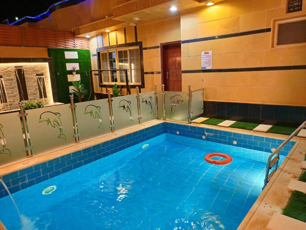 a swimming pool with a red frisbee in it at شالية سحاب in Rayyis