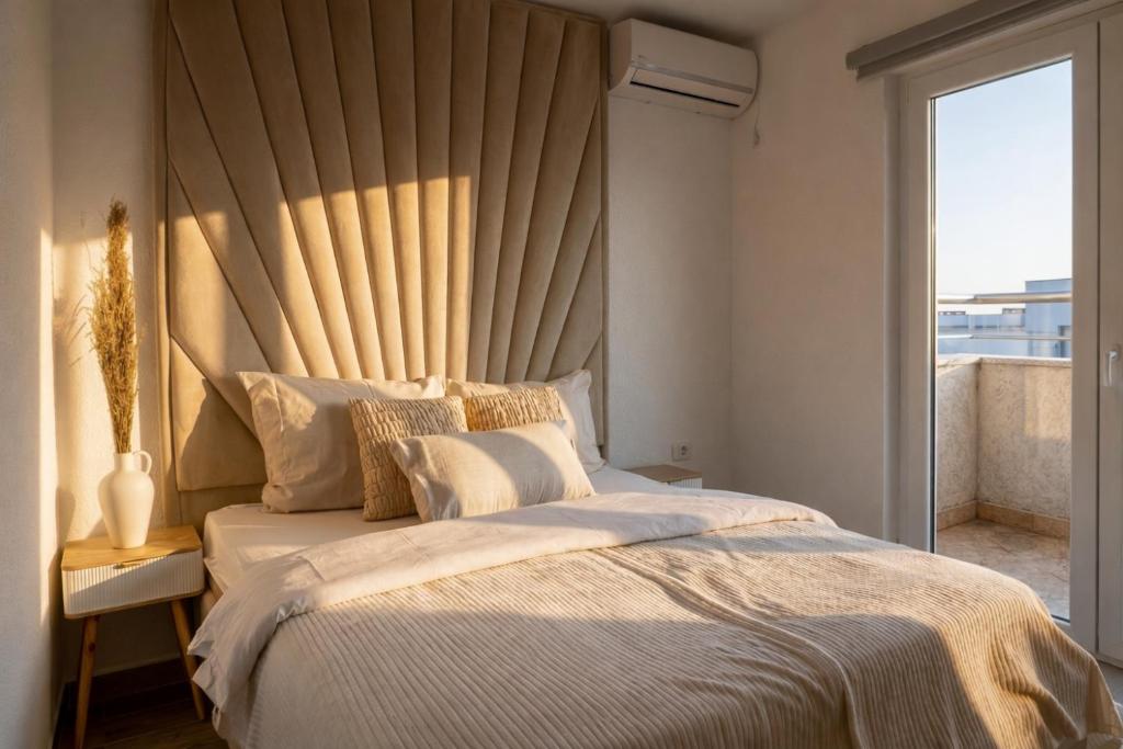 a bedroom with a large bed with a large window at Villa Alera in Dobra Voda