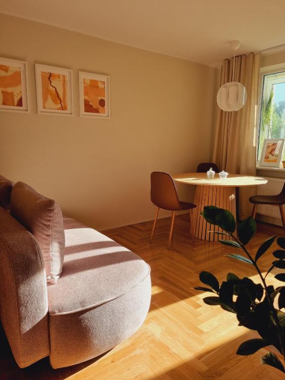 a living room with a chair and a table at S1 Vilnius in Vilnius
