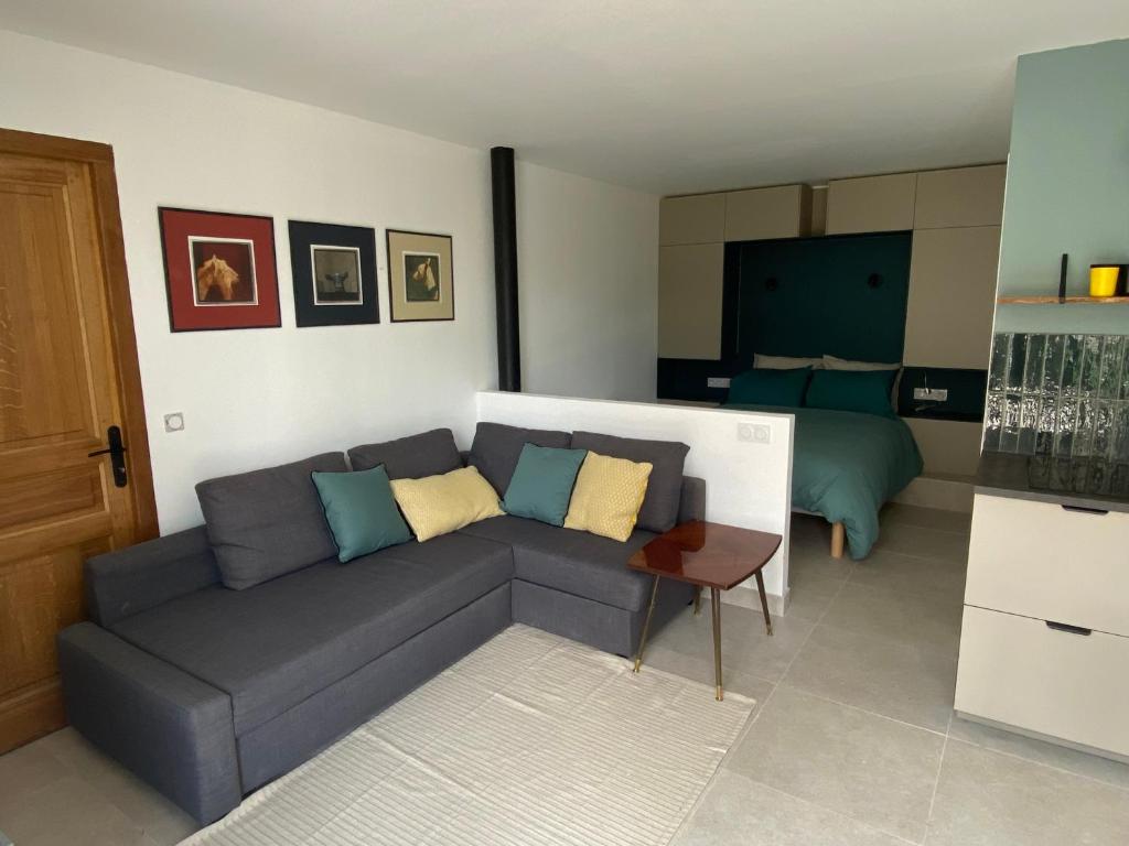 a living room with a couch and a bed at Le Narlay in Le Frasnois