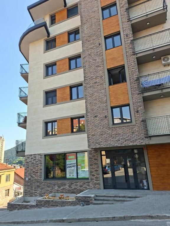 a tall building with a sign in front of it at Narcis in Užice
