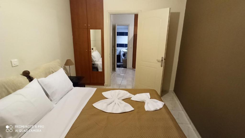 a bedroom with a bed with two napkins on it at Margerita in Mytilene