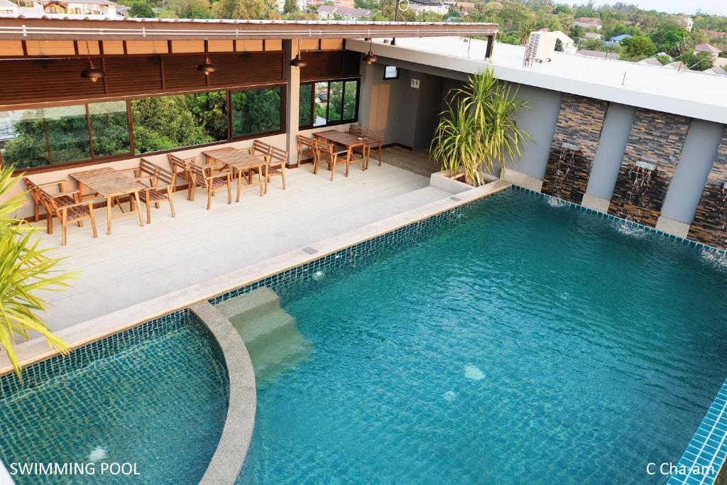 a swimming pool on the roof of a house at C Cha-Am Hotel in Cha Am