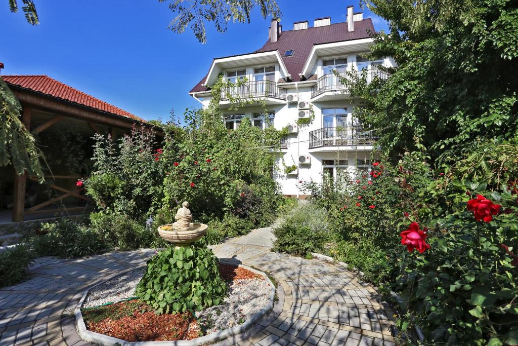 a garden in front of a building with a fountain at Mechta in Koktebel