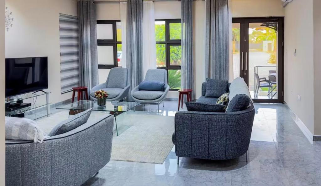 a living room with two couches and a tv at Sable Suites B2, 2 & 3 Bed Apartments in Kabulonga in Lusaka