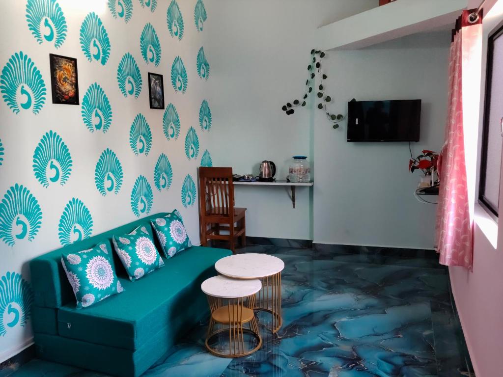 a living room with a green couch and a table at Auro Delight - Near Auroville in Pondicherry in Villupuram
