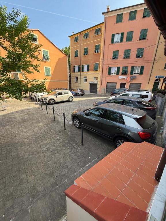 a parking lot with cars parked in front of buildings at Appartamento LUNA in Mele