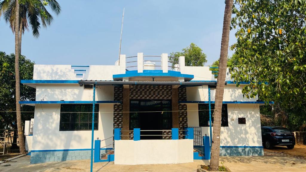 a house with a blue and white facade at Arabian Shore - Udupi in Malpe