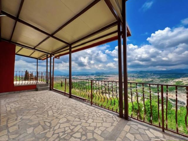 a room with a balcony with a view of a vineyard at Villa Ivanovic in Podgorica