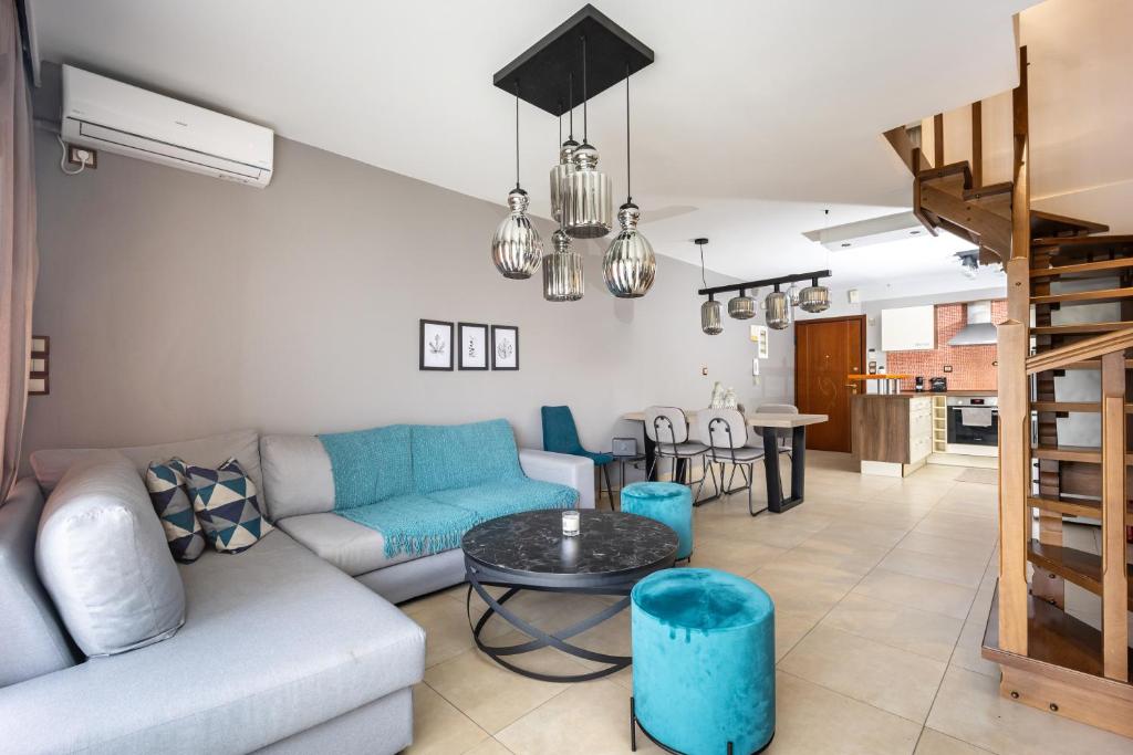 a living room with a couch and a table at Charming Maisonette In Southern Suburbs in Athens