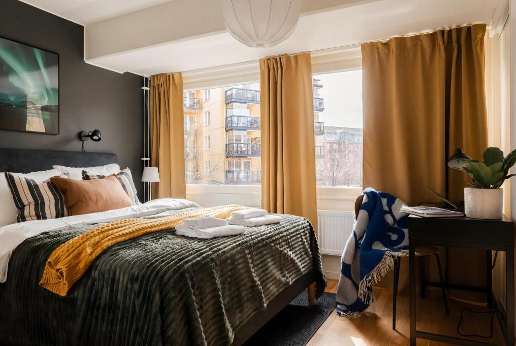 a bedroom with a bed and a window at Guestly Homes - Central Premium Suite 1BR in Västerås