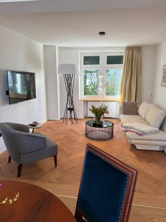 a living room with a couch and a table at Haus Enisa in Horgen