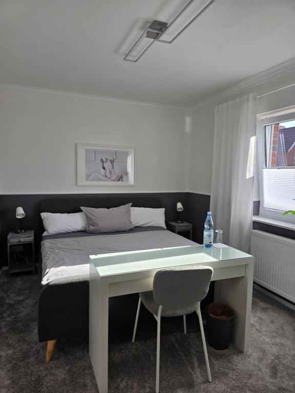 a bedroom with a bed and a desk with a bed at Privatunterkunft Bingum in Leerort