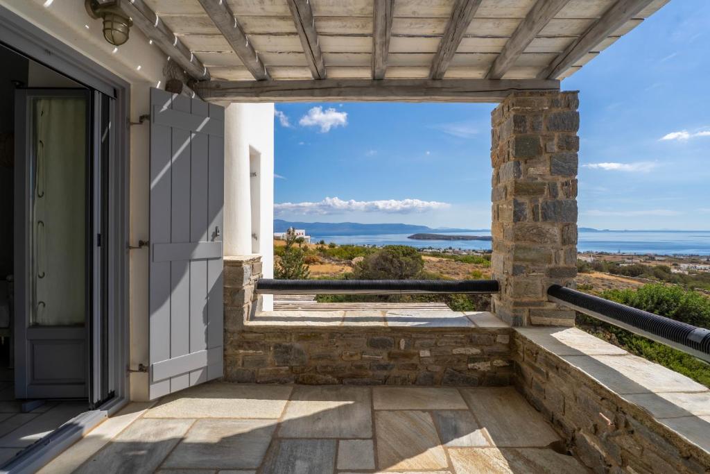 a porch with a view of the ocean at Infinity Blue - Villa A in Aspro Chorio Paros