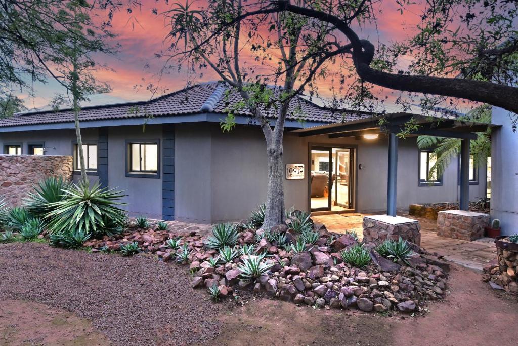 a house with a tree in the front yard at Elements Private Golf Reserve 109 in Moheme
