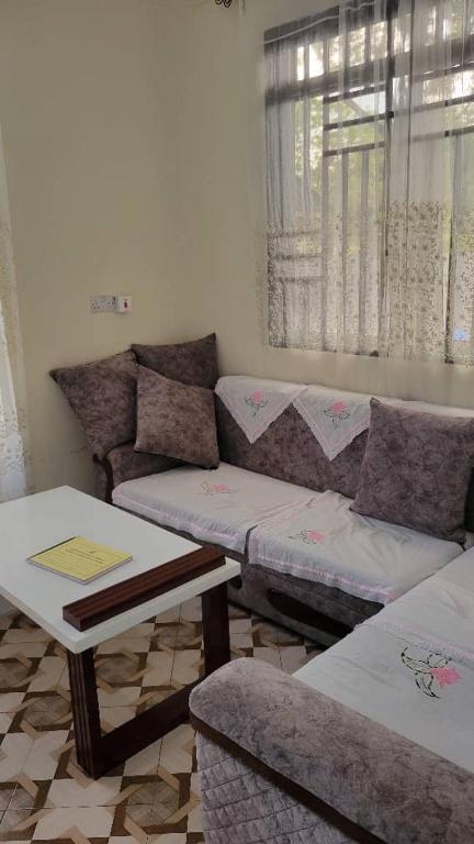 a living room with a couch and a table at Mamayi Homestay in Mto wa Mbu