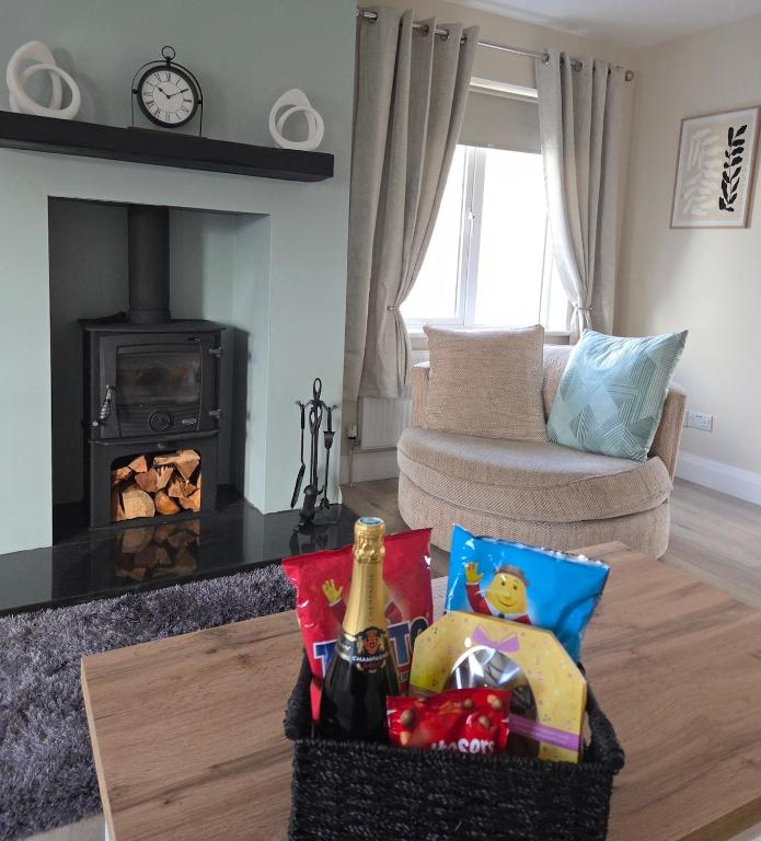 a living room with a table and a fireplace at Teach Na Dálaigh in Annagry