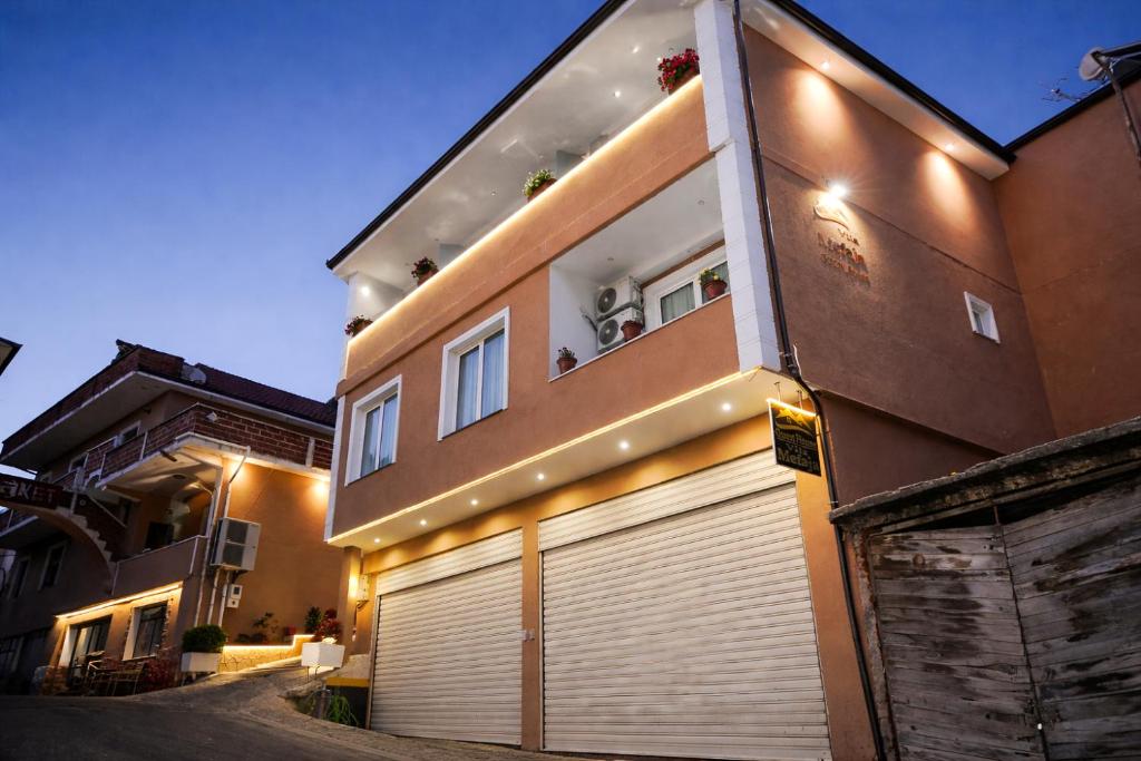 a building with a garage door in front of it at Villa Mefaja in Krujë