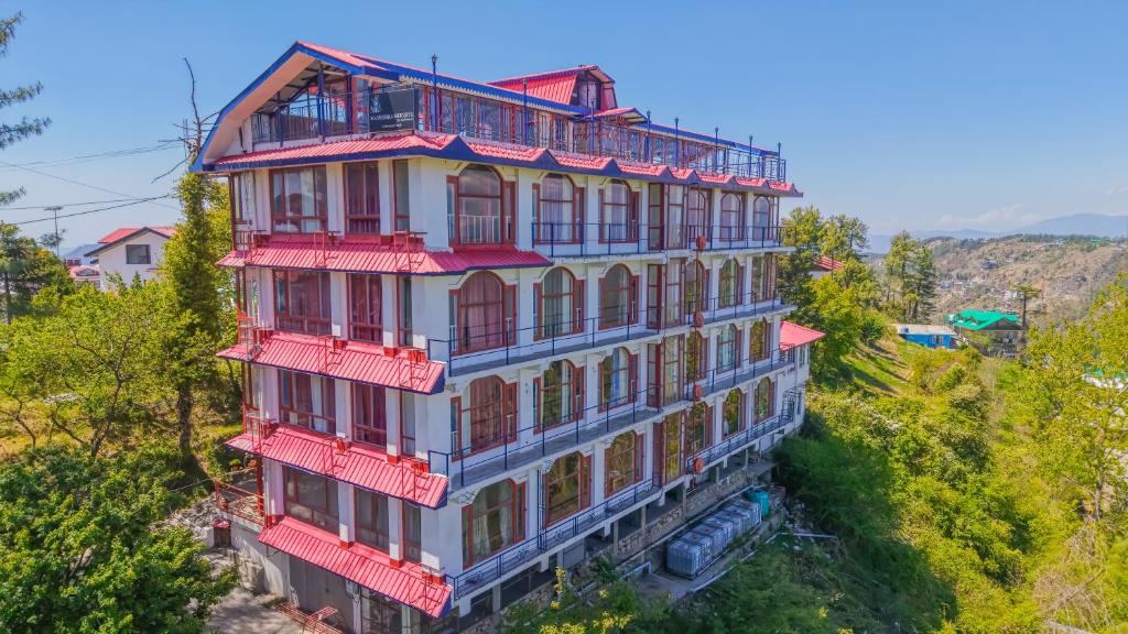 an overhead view of a building with red balconies at Mashobra Heights By shrpl in Kīar