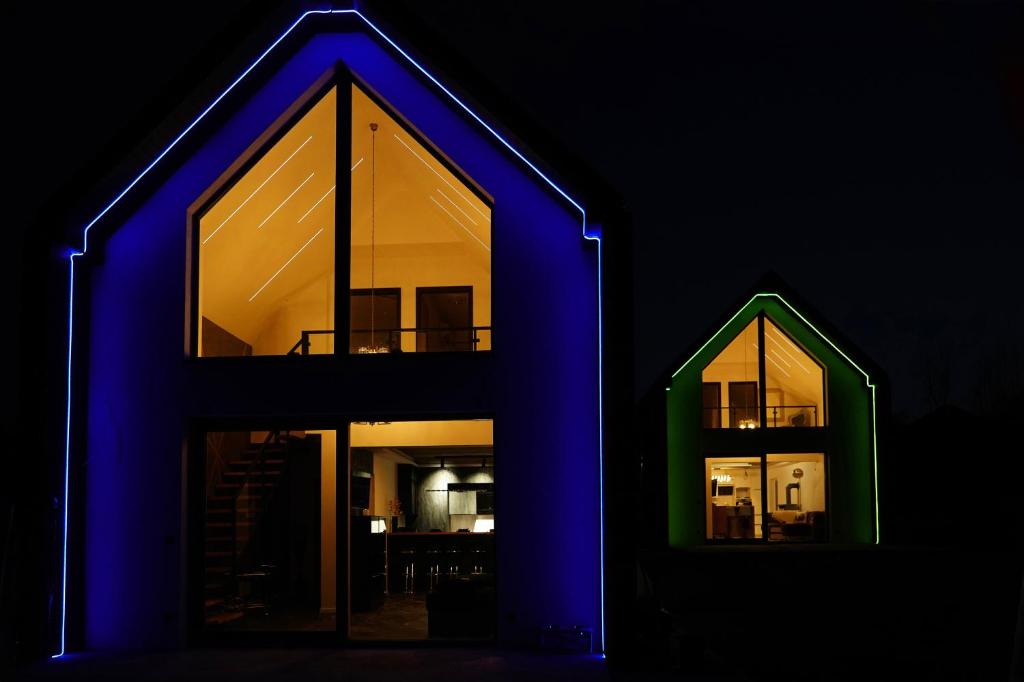 a house with blue lights on the front of it at Królowa Beskidu in Słopnice